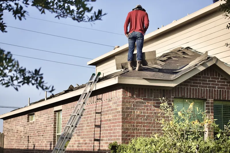 Professional roofer working on a residential roof in North Franklinton
